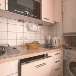 Den Abwasch erledigt die Spülmaschine. Vorräte sind im Kühlschrank mit Gefrierfach gut untergebracht. Im Bedarfsfalle steht die Waschmaschine bereit.